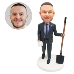 custom bobble head figure male boss holding a shovel and a roll paper