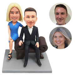 personalised bobble heads figures couple sitting on the sofa