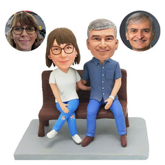 customised bobbleheads figures couple sitting on bench