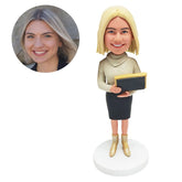 custom made bobblehead female teacher holding a black board