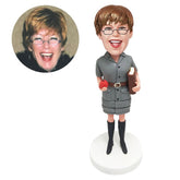 custom made bobblehead female teacher holding a book and an apple