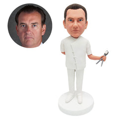 personalised bobble head figure male dentist holding a dental forcep