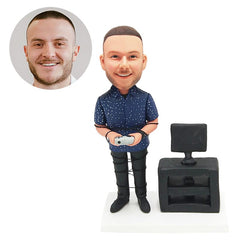 customised bobblehead figure man holding a game machine with a computer