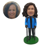 customised female climber bobblehead in blue jacket hiking with crutches