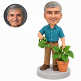 custom bobblehead figure older male gardener with a watering can and potted plant