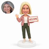 custom bobblehead figure woman waving while holding a welcome sign
