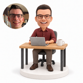 custom bobblehead figure man working at a desk with a laptop and coffee