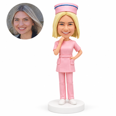 custom bobblehead figure nurse in a pink uniform with a hand at her chin