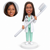 custom bobblehead figure female dentist holding a large toothbrush with both hands
