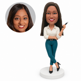 custom bobblehead figure businesswoman holding a pen with her opposite arm supporting the elbow