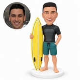 custom bobblehead figure male surfer in a short-sleeve wetsuit top with one hand in his pocket
