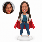 custom bobblehead figure woman in an open plaid shirt and cape with both hands in her jeans pockets