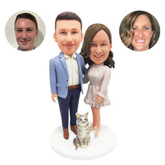 customised bobblehead figure couple with arms around each other with a pet
