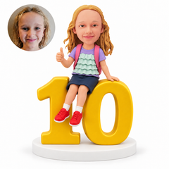 custom bobblehead figure girl sitting on a large number 10 with a thumbs-up pose