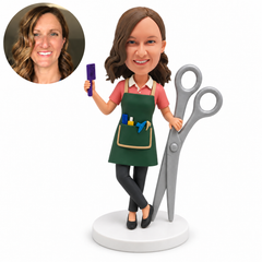 custom bobblehead figure female hairdresser beside oversized scissors holding a comb