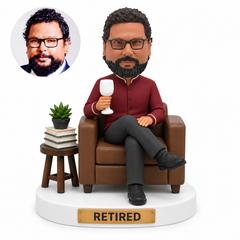 custom bobblehead figure retired man seated in an armchair holding a goblet beside books and a plant