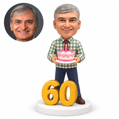 custom bobblehead figure man holding a birthday cake beside a large number 60
