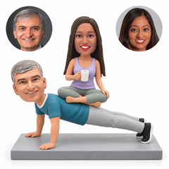 custom bobblehead figures couple with the man in a straight-arm push-up and the woman sitting cross-legged on his back holding a cup