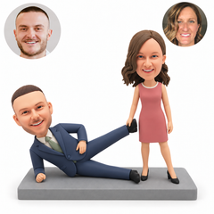 custom bobblehead figures couple with the man reclining on one elbow and the standing woman holding his raised ankle