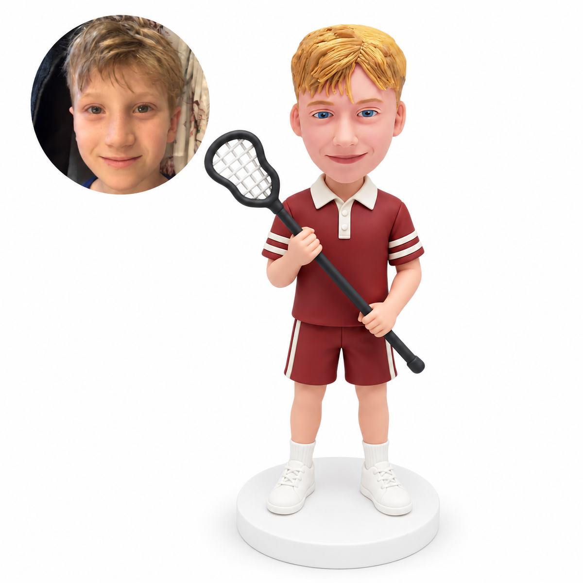 Boy lacrosse player holding one upright dark stick with both hands, wearing a maroon sports uniform.