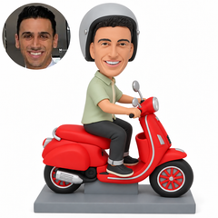 custom bobblehead figure man riding a scooter with both hands on the handlebars and both feet on the step platform