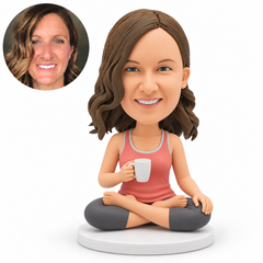 custom bobblehead figure woman sitting cross-legged with a mug in her right hand and her left hand resting on her knee