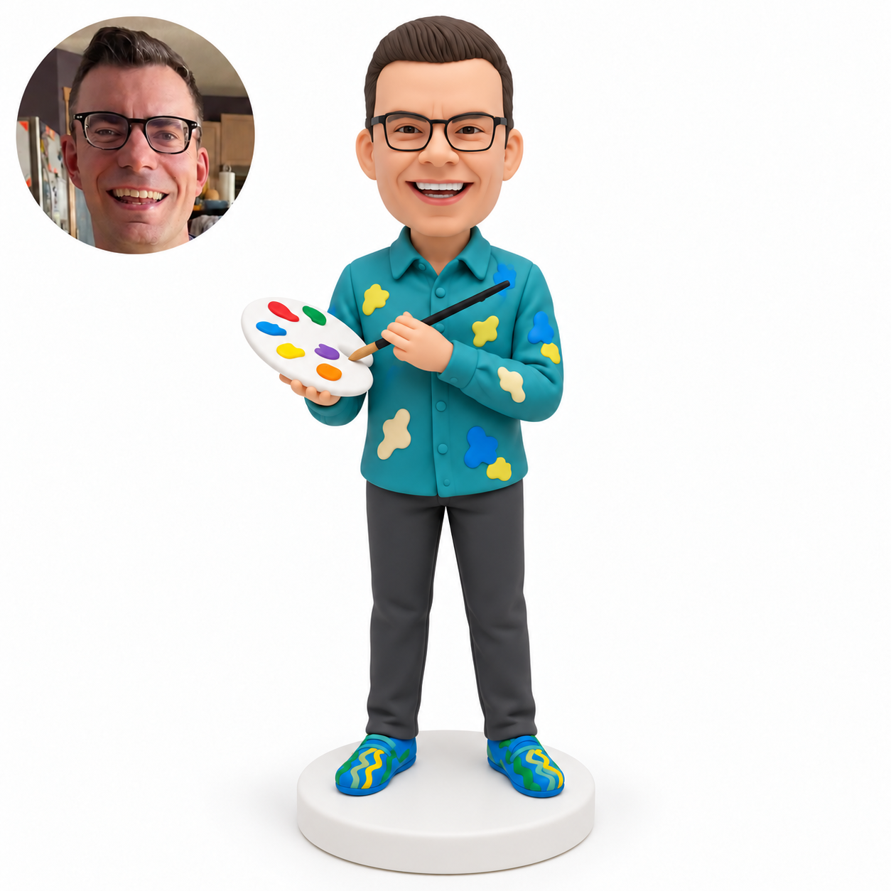custom bobblehead figure male artist holding a palette at his chest with his right hand and directing a paintbrush toward it with his left