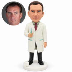 custom bobblehead figure male dentist holding an upright toothbrush in his right hand with his left arm lowered and a small tooth model on the base