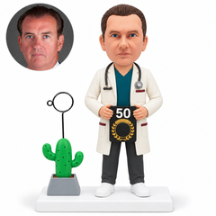 custom bobblehead figure male doctor holding a 50 plaque with both hands beside a cactus memo-ring ornament