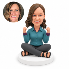 custom bobblehead figure woman sitting cross-legged with both empty fists raised beside her shoulders