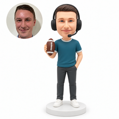 custom bobblehead figure male sports commentator wearing a headset holding an upright football in his right hand with his left hand in his pocket
