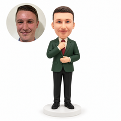 custom bobblehead figure man in a suit touching his tie knot with his right hand and resting his left palm across his abdomen