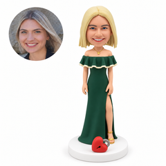custom bobblehead figure woman standing in a slit gown beside a fixed heart shaped padlock on the base