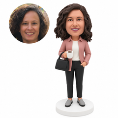 custom bobblehead figure woman holding a cup with a handbag hanging from the same forearm and her other hand in her pocket