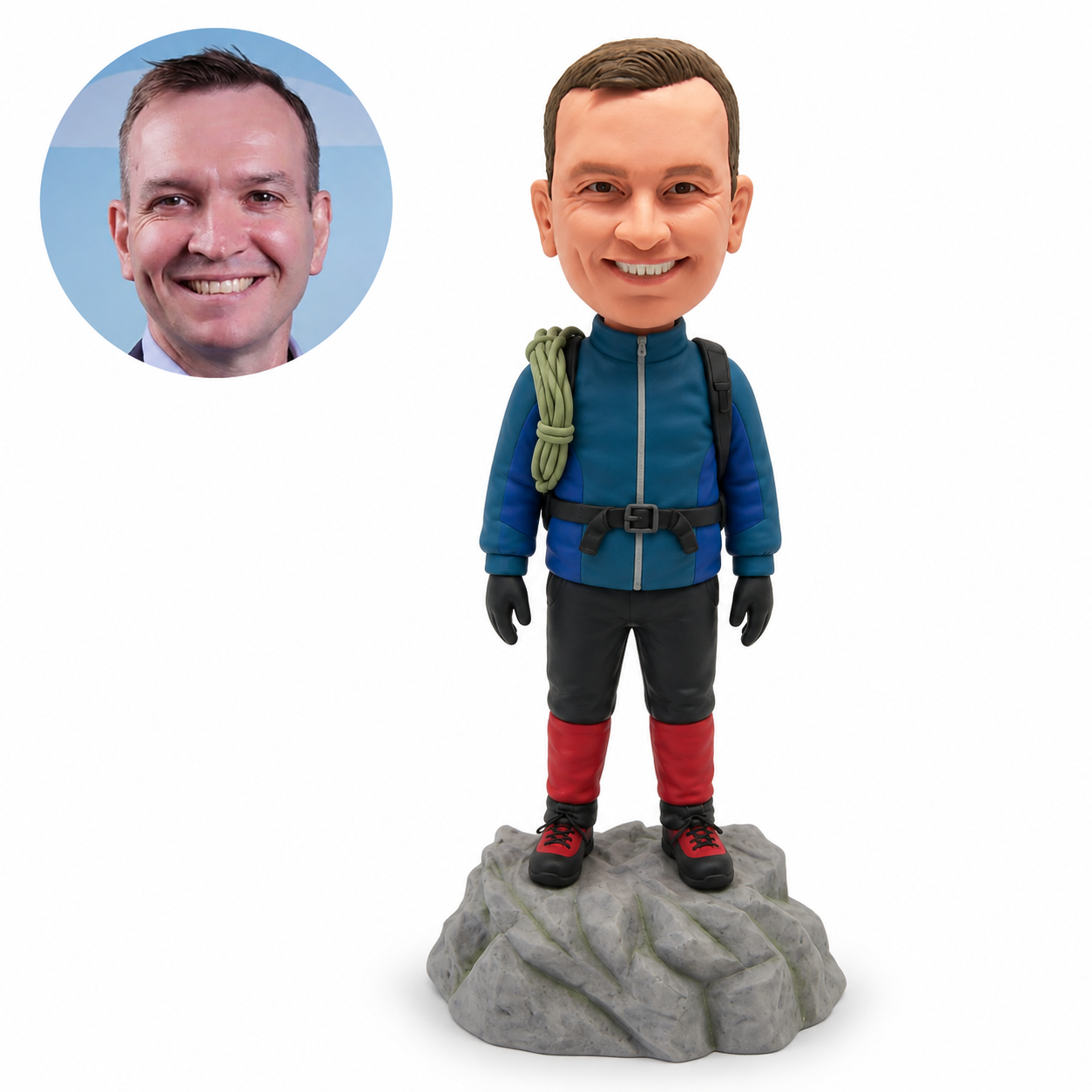 Custom male climber bobblehead standing on a rocky summit with coiled rope on one shoulder