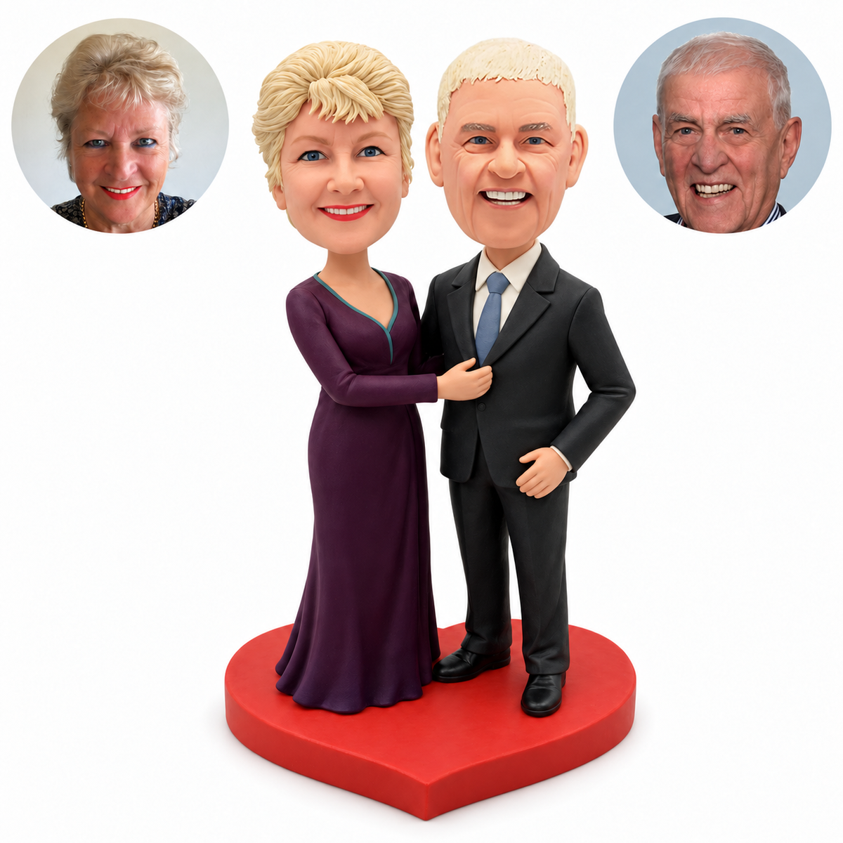 Custom clay anniversary couple bobbleheads: older woman in a plum gown touching a suited man’s lapel, his open hand at his hip, on a red heart base with two matching real portrait photos