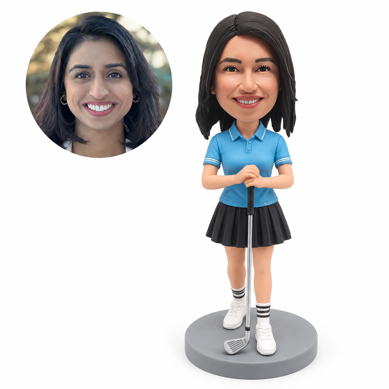 Custom female golfer bobblehead in a blue polo and pleated skirt holding a grounded golf club, with matching real photo portrait