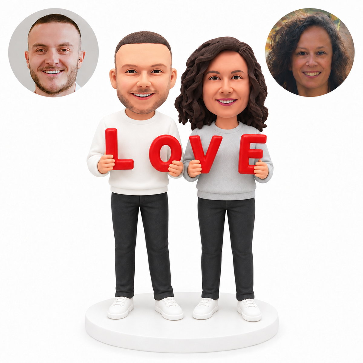 Custom couple bobblehead with man on left holding L and O and woman on right holding V and E, on a white base