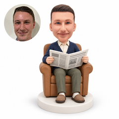 custom bobblehead figure man reading a newspaper in an armchair