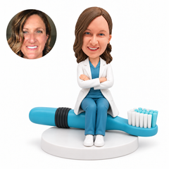 custom bobblehead figure female dentist seated on a giant toothbrush