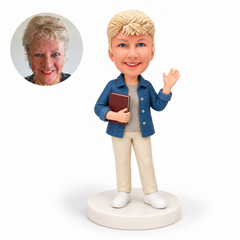 custom bobblehead figure woman waving while holding a book