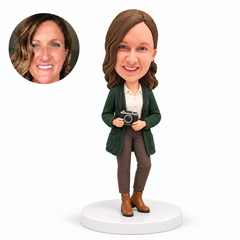 custom bobblehead figure female photographer in a coat holding a camera