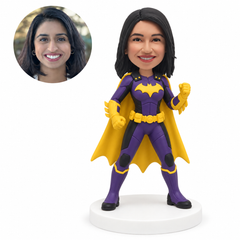 custom bobblehead figure woman in a purple hero suit with a yellow cape