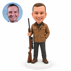 custom bobblehead figure hunter holding a rifle upright beside his boots