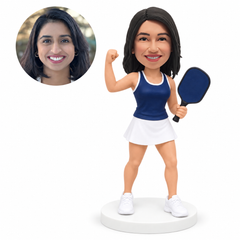 custom bobblehead figure female pickleball player celebrating with a raised fist