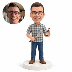 custom bobblehead figure man in a plaid shirt holding a spatula and beer bottle