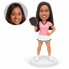 custom bobblehead figure woman in a skirt holding a pickleball paddle