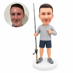 custom bobblehead figure fisherman holding a long rod and pointing to his shirt