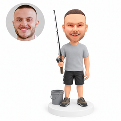 custom bobblehead figure fisherman holding a rod beside a bucket