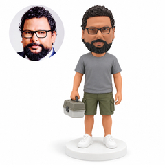 custom bobblehead figure fisherman holding a tackle box at his side